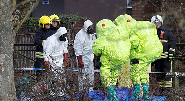 Investigators in protective suits